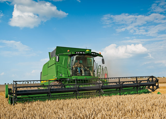 A Deere combine harvester in action